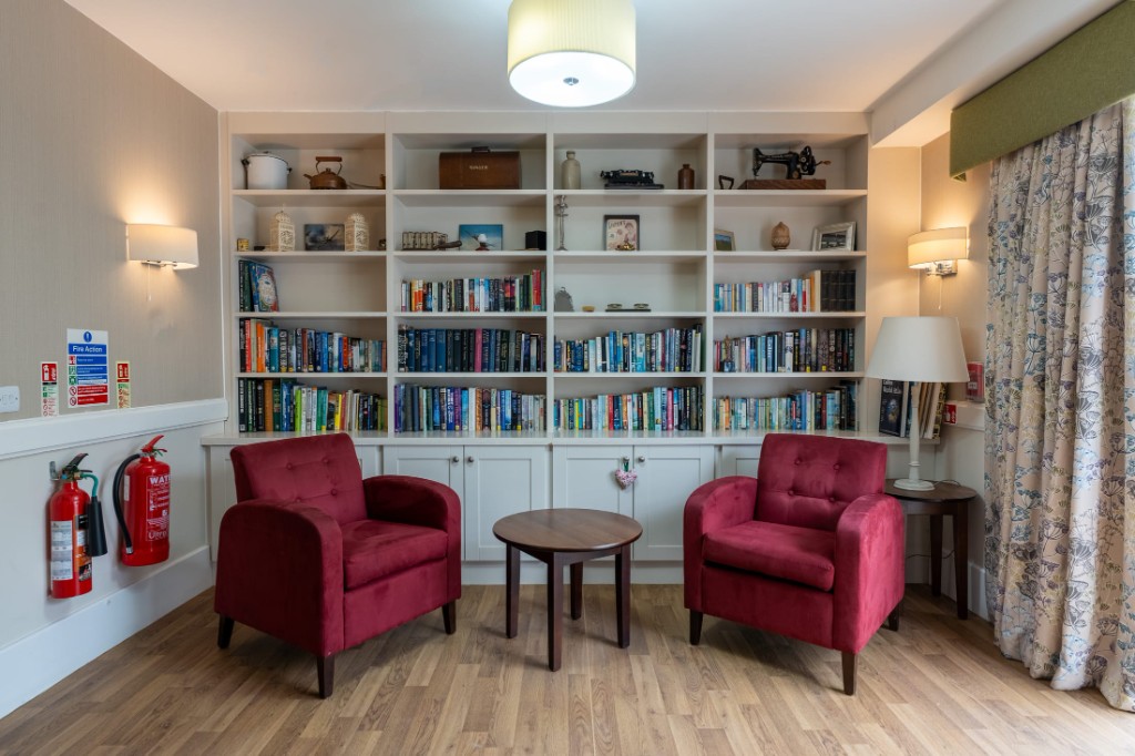 Lounge with bookshelves and armchairs at California House
